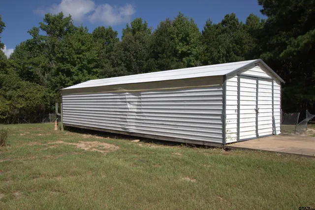 a view of a backyard with a small cabin