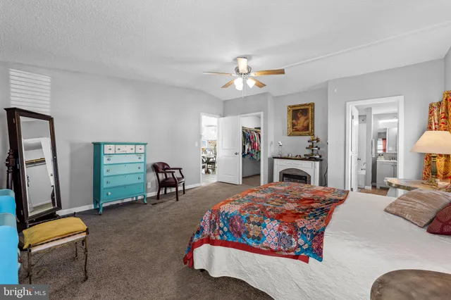 a bedroom with a bed dresser and a flat screen tv