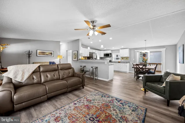 a living room with furniture and kitchen view