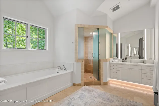 a large bedroom with a large bed and a large window