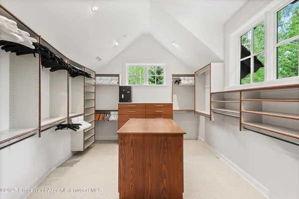 a room with pool table and windows