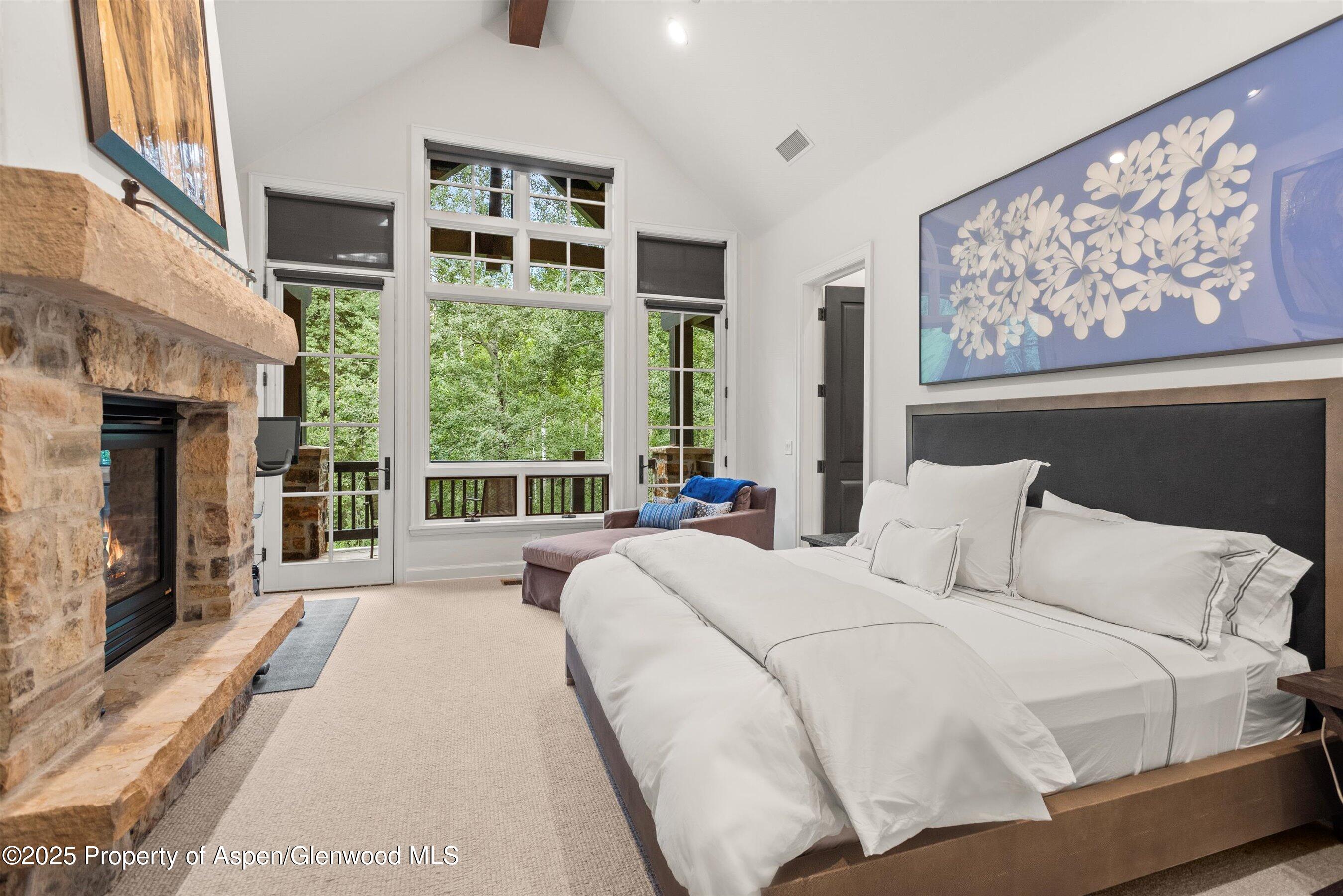 289 Exhibition Lane Aspen, CO 81611 - Photo 15 of 46 a large bedroom with a large bed and a large window