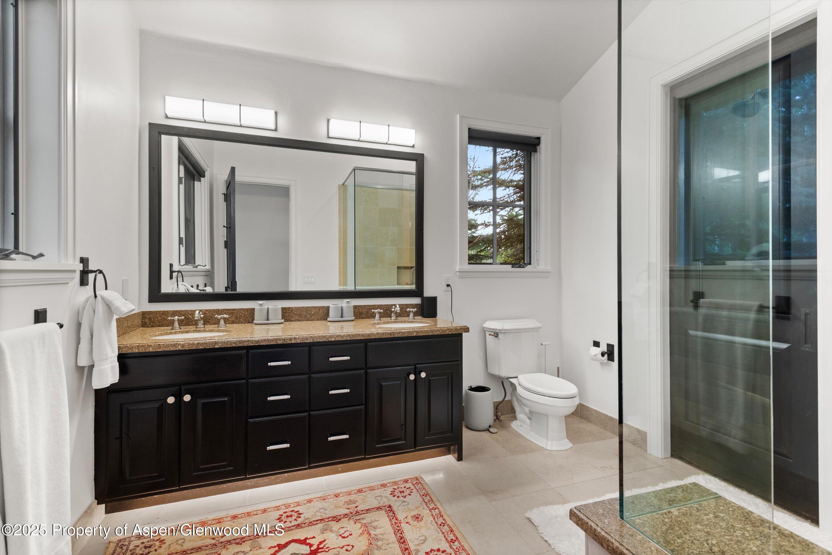 289 Exhibition Lane Aspen, CO 81611 - Photo 17 of 46 a bathroom with a double vanity sink and a mirror