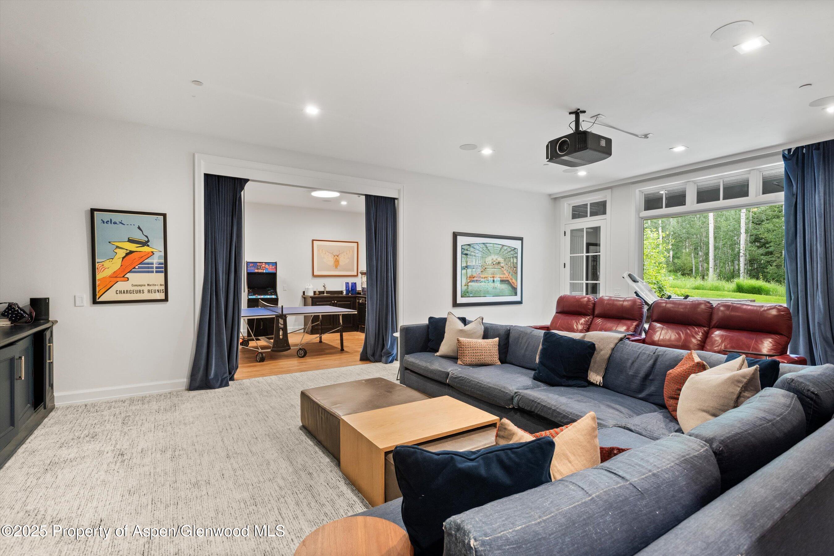 289 Exhibition Lane Aspen, CO 81611 - Photo 19 of 46 a living room with furniture and a large window