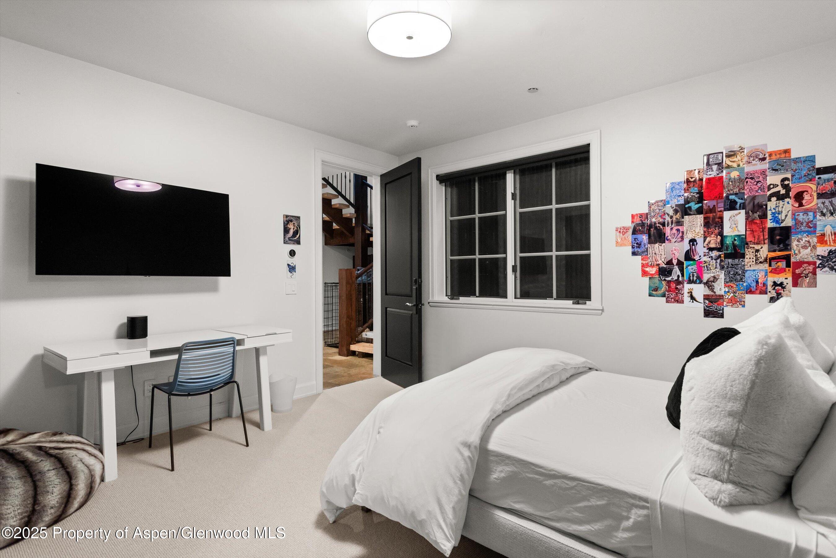 289 Exhibition Lane Aspen, CO 81611 - Photo 24 of 46 a bedroom with a bed and a flat screen tv