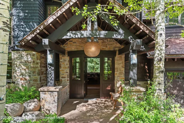 a front view of a house with a yard table and chairs
