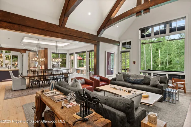 a living room with furniture and floor to ceiling windows