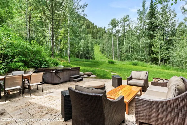 a view of a patio with couches chairs and a yard