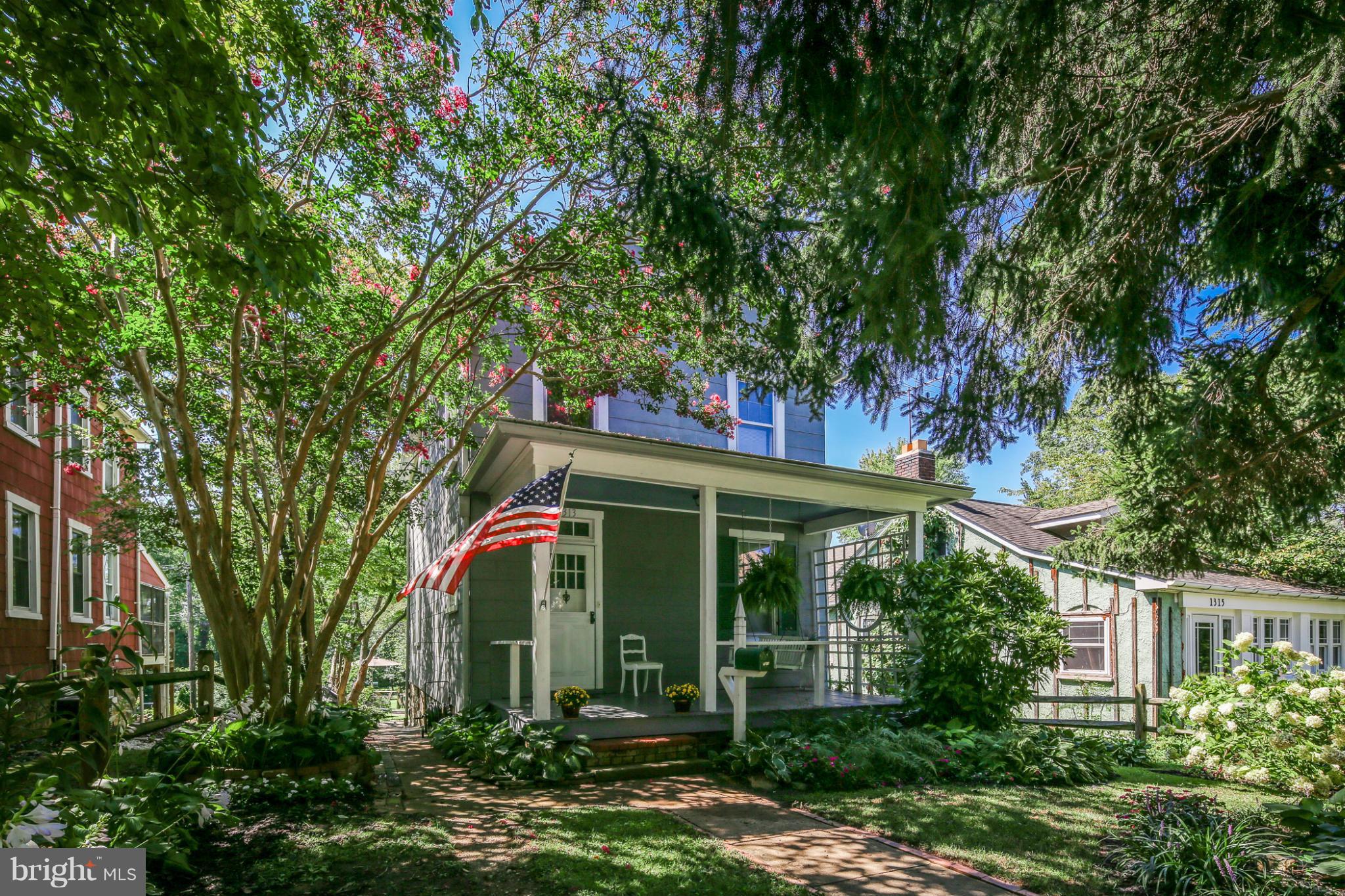 1313 Asbury Road Baltimore, MD 21209 - Photo 2 of 30 front view of a house with a tree