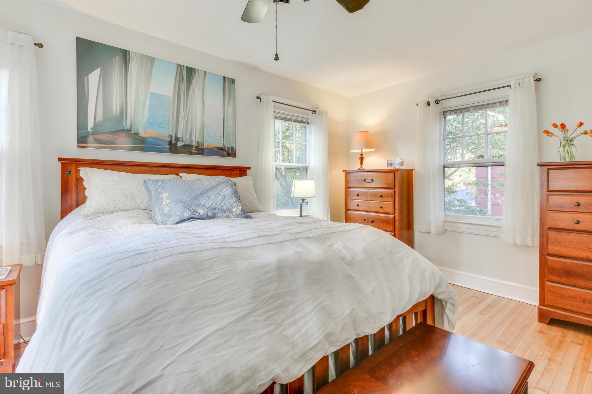 1313 Asbury Road Baltimore, MD 21209 - Photo 15 of 30 a bedroom with a large bed and wooden floor