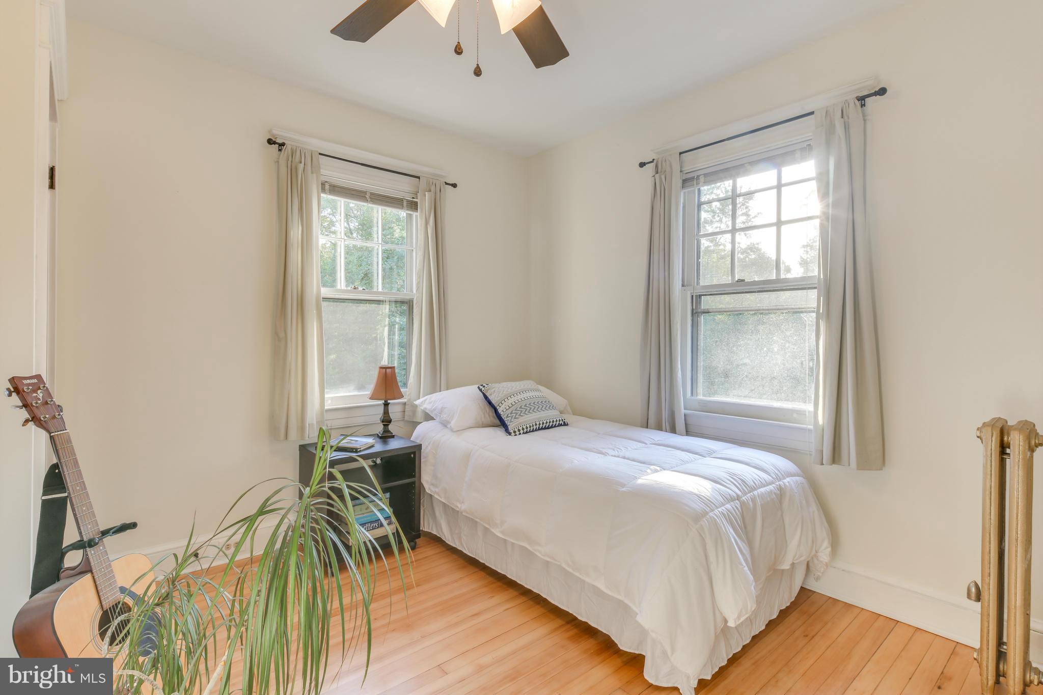 1313 Asbury Road Baltimore, MD 21209 - Photo 18 of 30 a bedroom with a bed and a chandelier