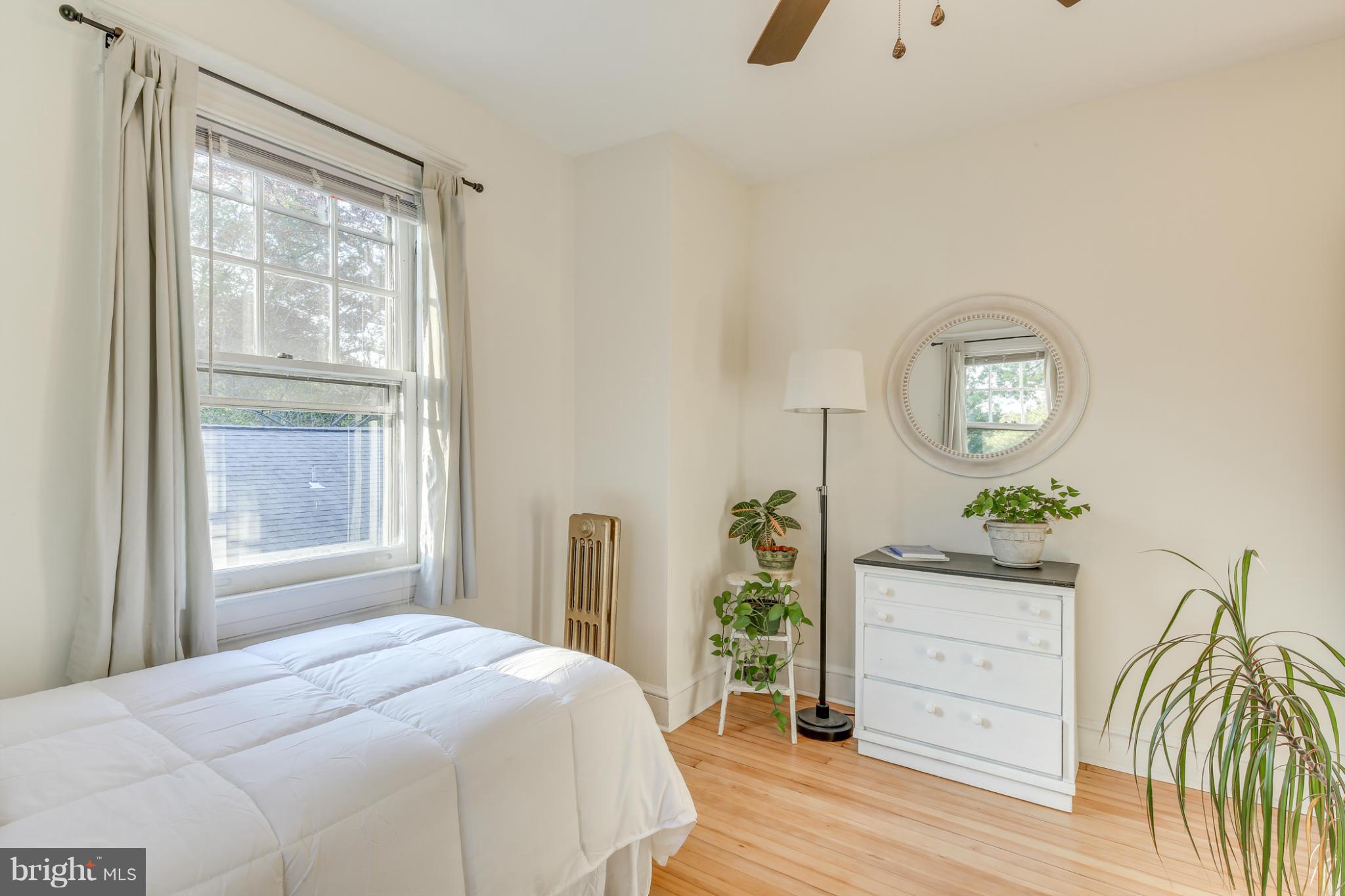 1313 Asbury Road Baltimore, MD 21209 - Photo 19 of 30 a bedroom with a bed and a window