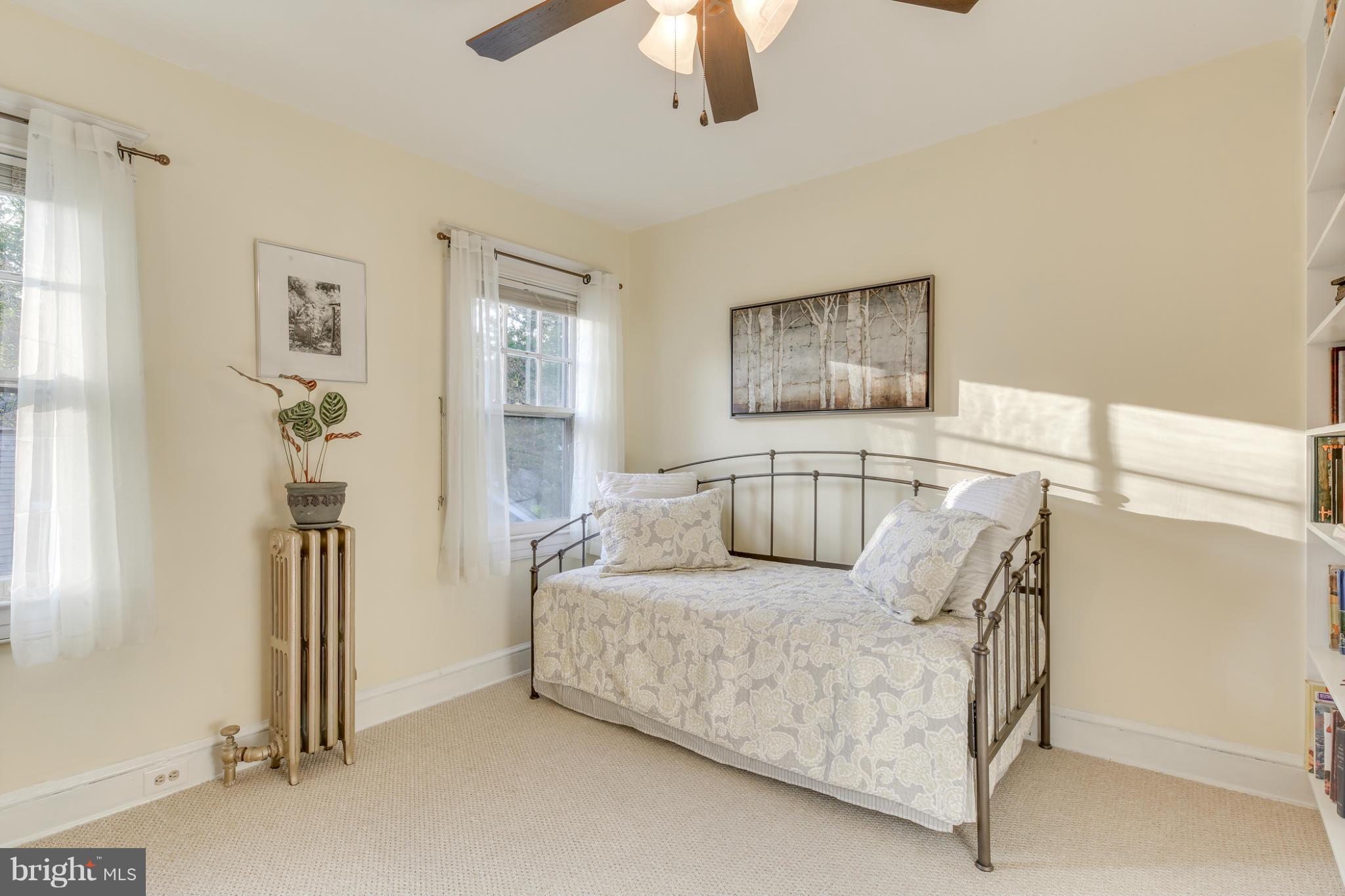 1313 Asbury Road Baltimore, MD 21209 - Photo 20 of 30 a bedroom with a bed and a chandelier