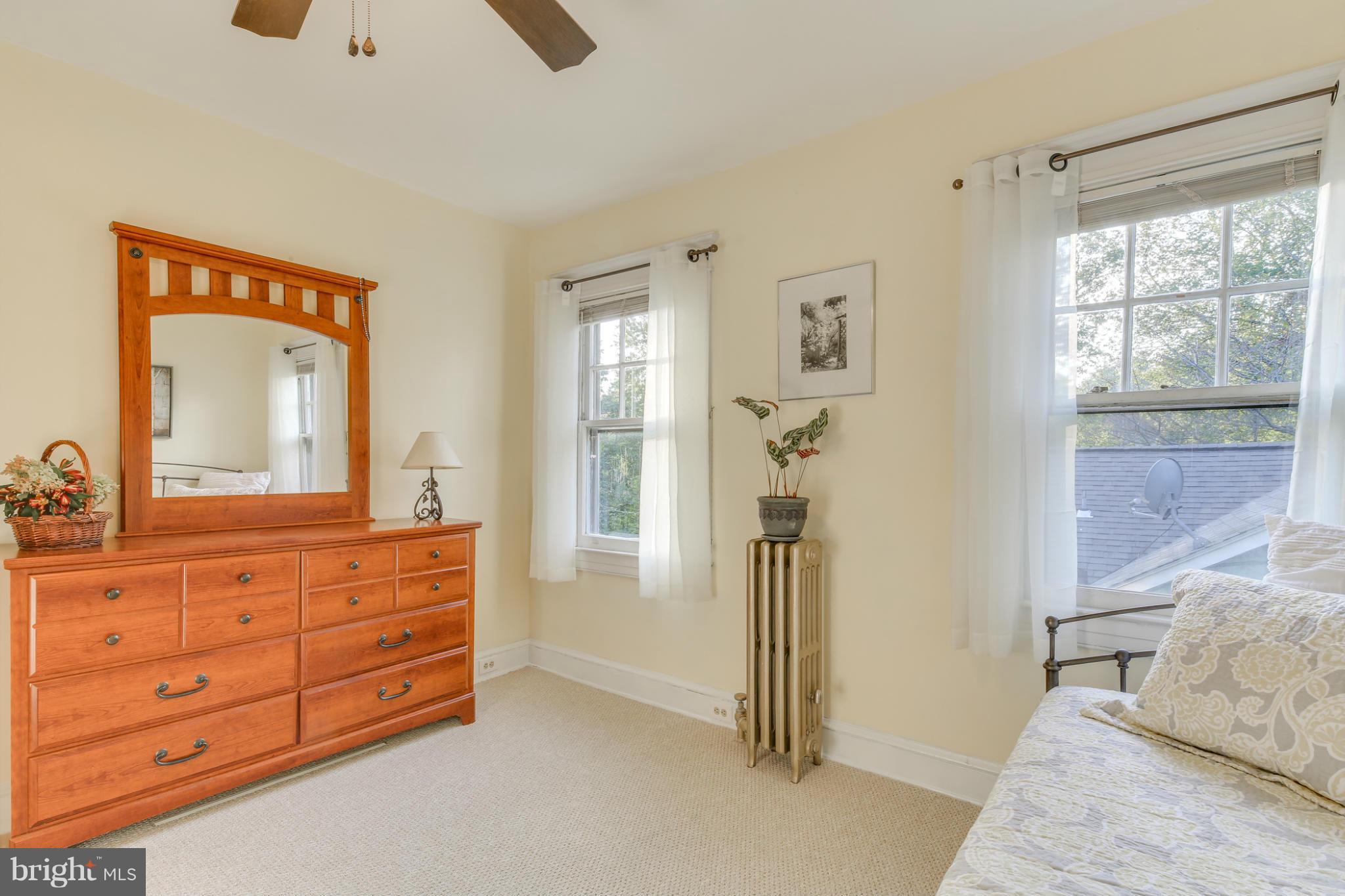 1313 Asbury Road Baltimore, MD 21209 - Photo 21 of 30 a room with a bed and a mirror on dresser