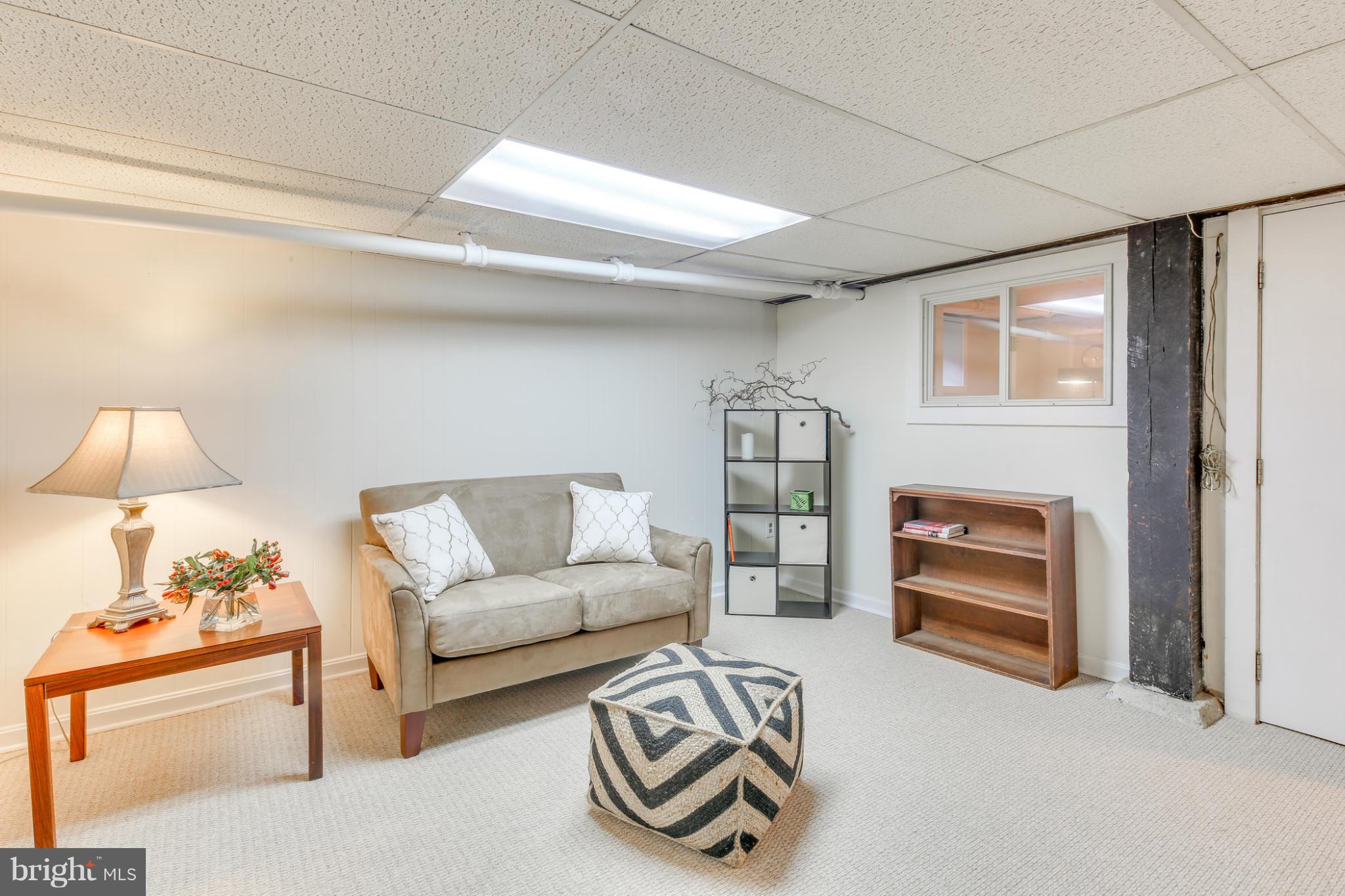 1313 Asbury Road Baltimore, MD 21209 - Photo 23 of 30 a living room with furniture and a lamp