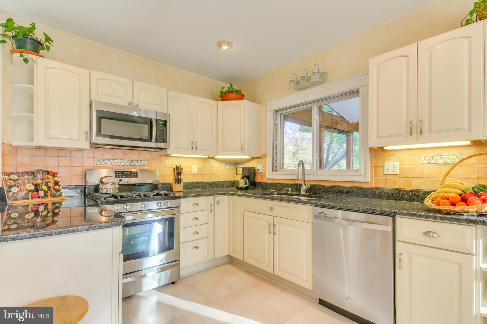 1313 Asbury Road Baltimore, MD 21209 - Photo 8 of 30 a kitchen with granite countertop white cabinets and white appliances