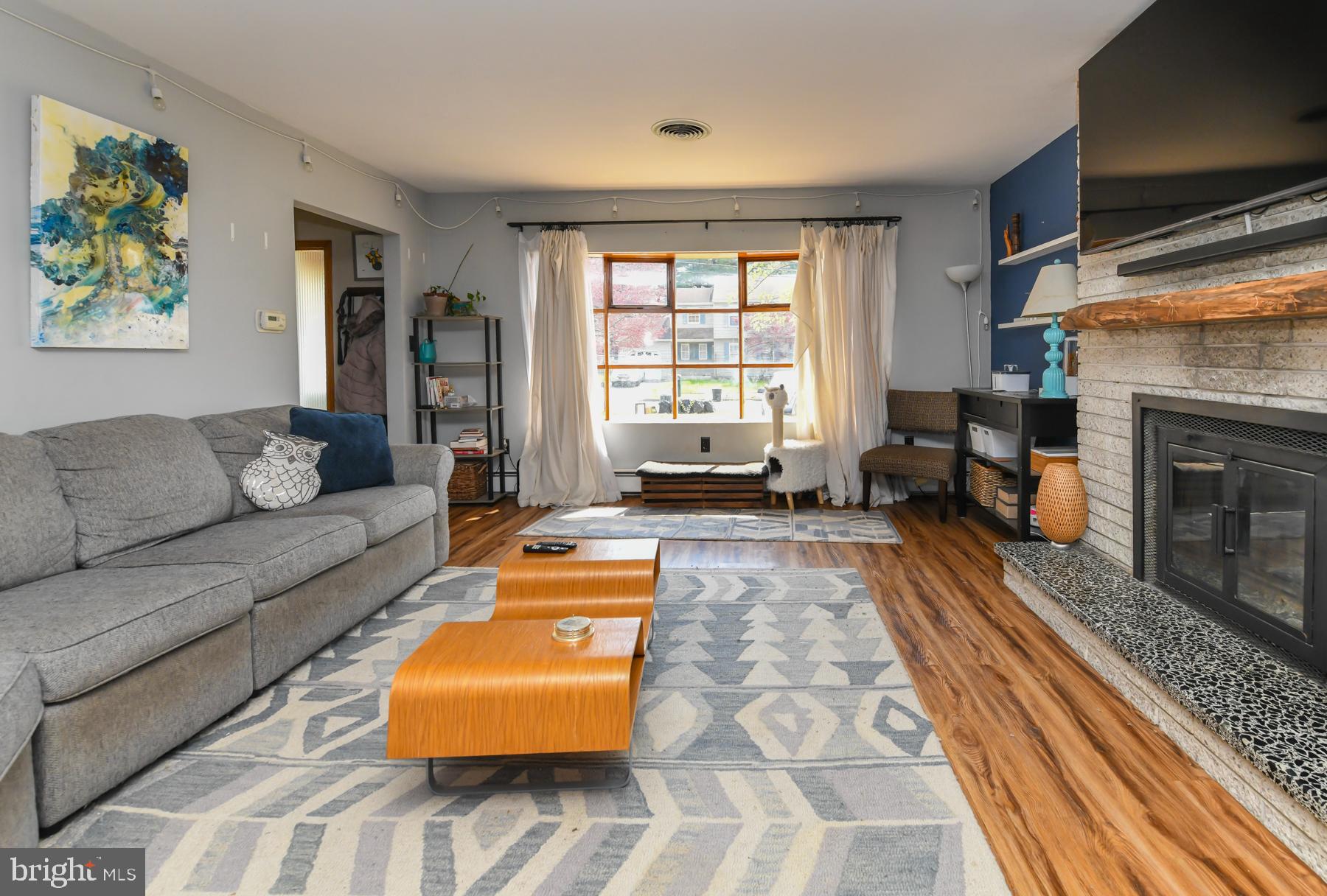 111 Atkins Avenue Hamilton, NJ 08610 - Photo 2 of 11 a living room with furniture and a fireplace
