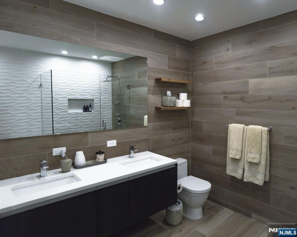 314 The Promenade Edgewater, NJ 07020 - Photo 22 of 37 a bathroom with a toilet sink and mirror