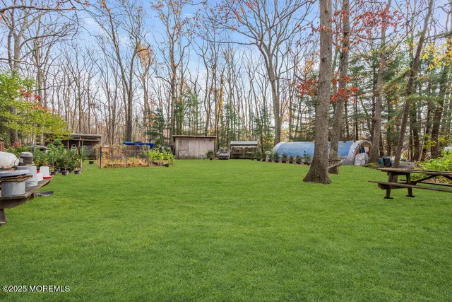 a backyard of a house with table and chairs