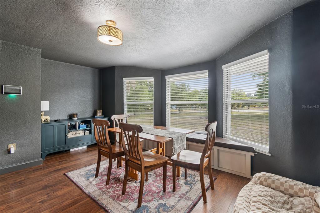 2301 West Eldred Drive Tampa, FL 33603 - Photo 12 of 34 a view of a dining room with furniture a rug and wooden floor