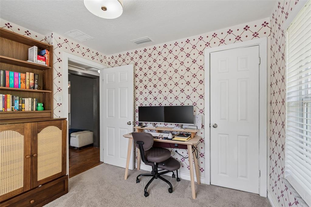 2301 West Eldred Drive Tampa, FL 33603 - Photo 14 of 34 a workspace with furniture and a book shelf