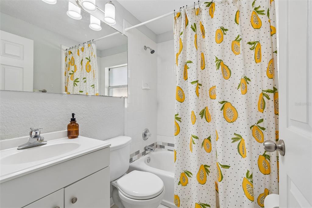 2301 West Eldred Drive Tampa, FL 33603 - Photo 16 of 34 a bathroom with a sink a toilet and shower curtain