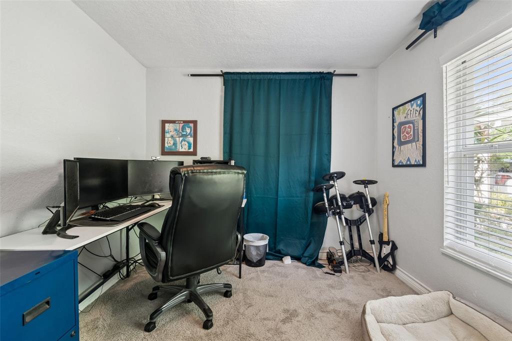 2301 West Eldred Drive Tampa, FL 33603 - Photo 19 of 34 a view of a workspace with furniture and a window