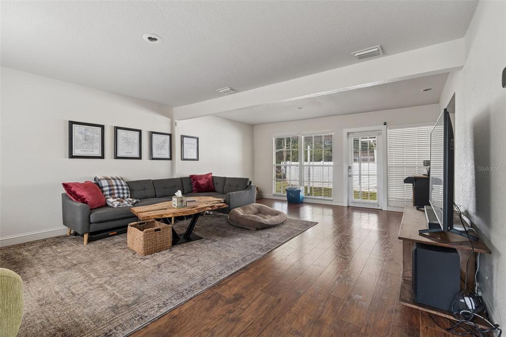 2301 West Eldred Drive Tampa, FL 33603 - Photo 6 of 34 a living room with furniture and wooden floor
