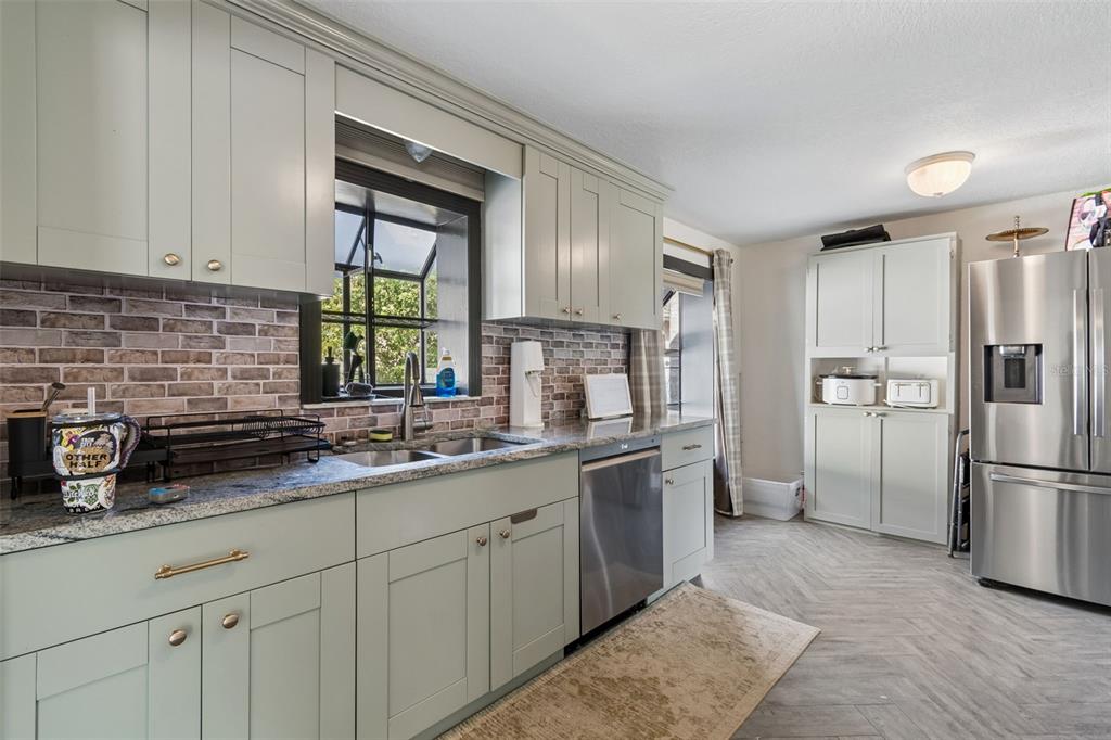 2301 West Eldred Drive Tampa, FL 33603 - Photo 8 of 34 a kitchen with a refrigerator and a sink