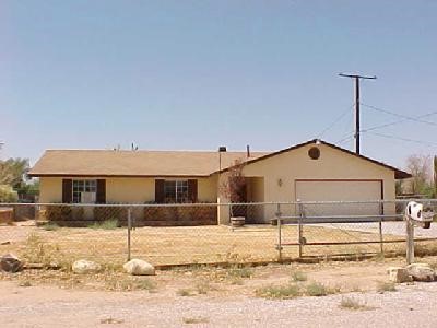 14216 Quinnault Road Apple Valley, CA 92307 - Photo 1 of 1 a front view of a house with a yard