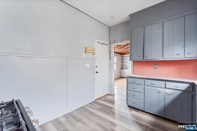 a kitchen with granite countertop white cabinets and sink