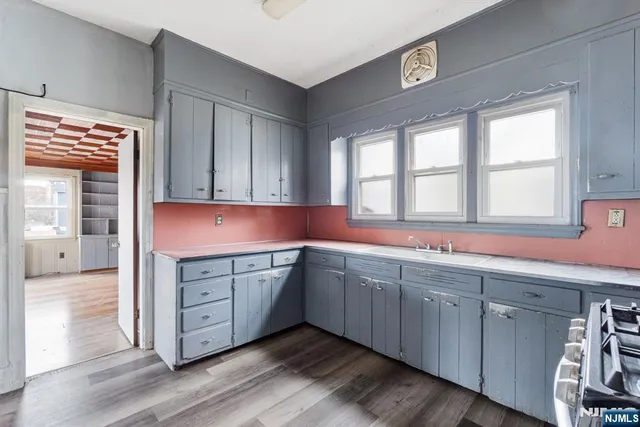 a kitchen with wooden cabinets and sink