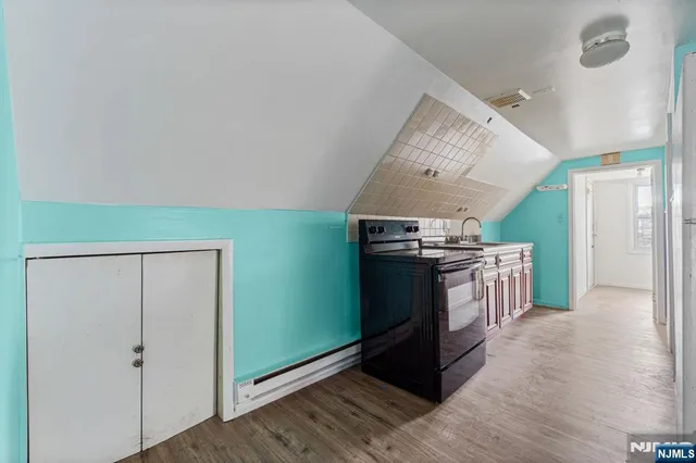 a kitchen with stainless steel appliances granite countertop a refrigerator and a wooden floors