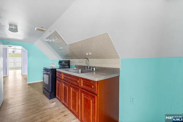 a kitchen with a sink and a refrigerator