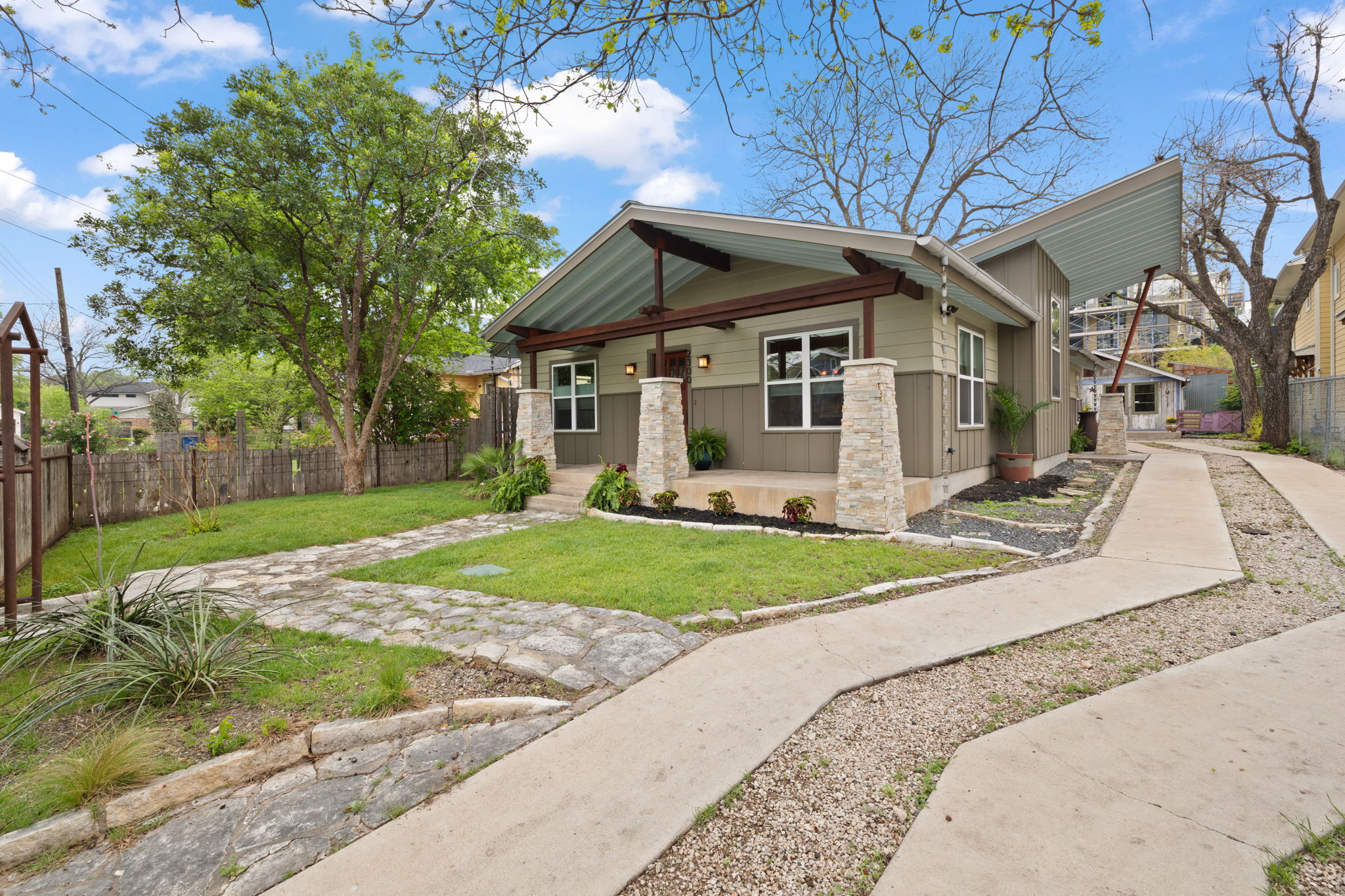View of front facade featuring fence and a front lawn