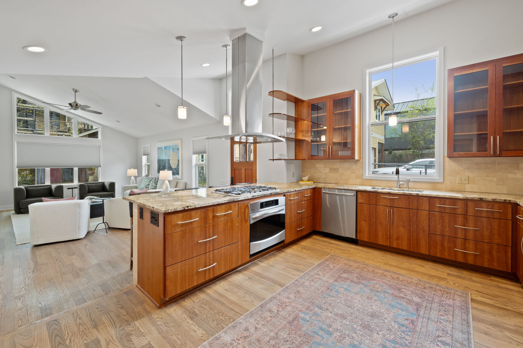 2300 South 3rd Street Austin, TX 78704 - Photo 12 of 39 Kitchen with stainless steel appliances, a sink, light stone counters, a peninsula, and brown cabinets