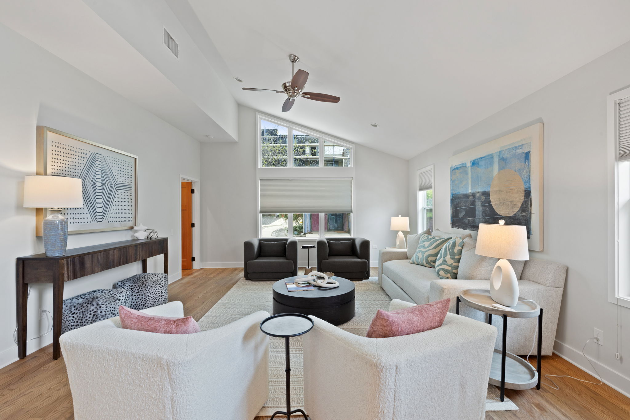2300 South 3rd Street Austin, TX 78704 - Photo 13 of 39 Living area with high vaulted ceiling, visible vents, baseboards, wood finished floors, and a ceiling fan