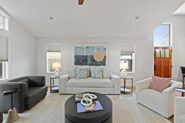a living room with furniture a rug and a window
