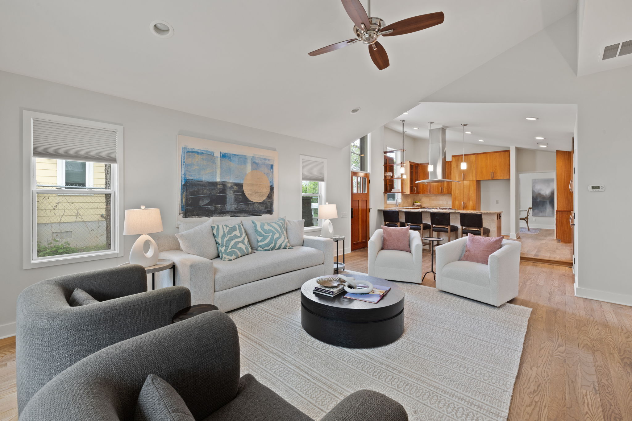2300 South 3rd Street Austin, TX 78704 - Photo 16 of 39 Living room featuring high vaulted ceiling, baseboards, visible vents, light wood-style floors, and ceiling fan