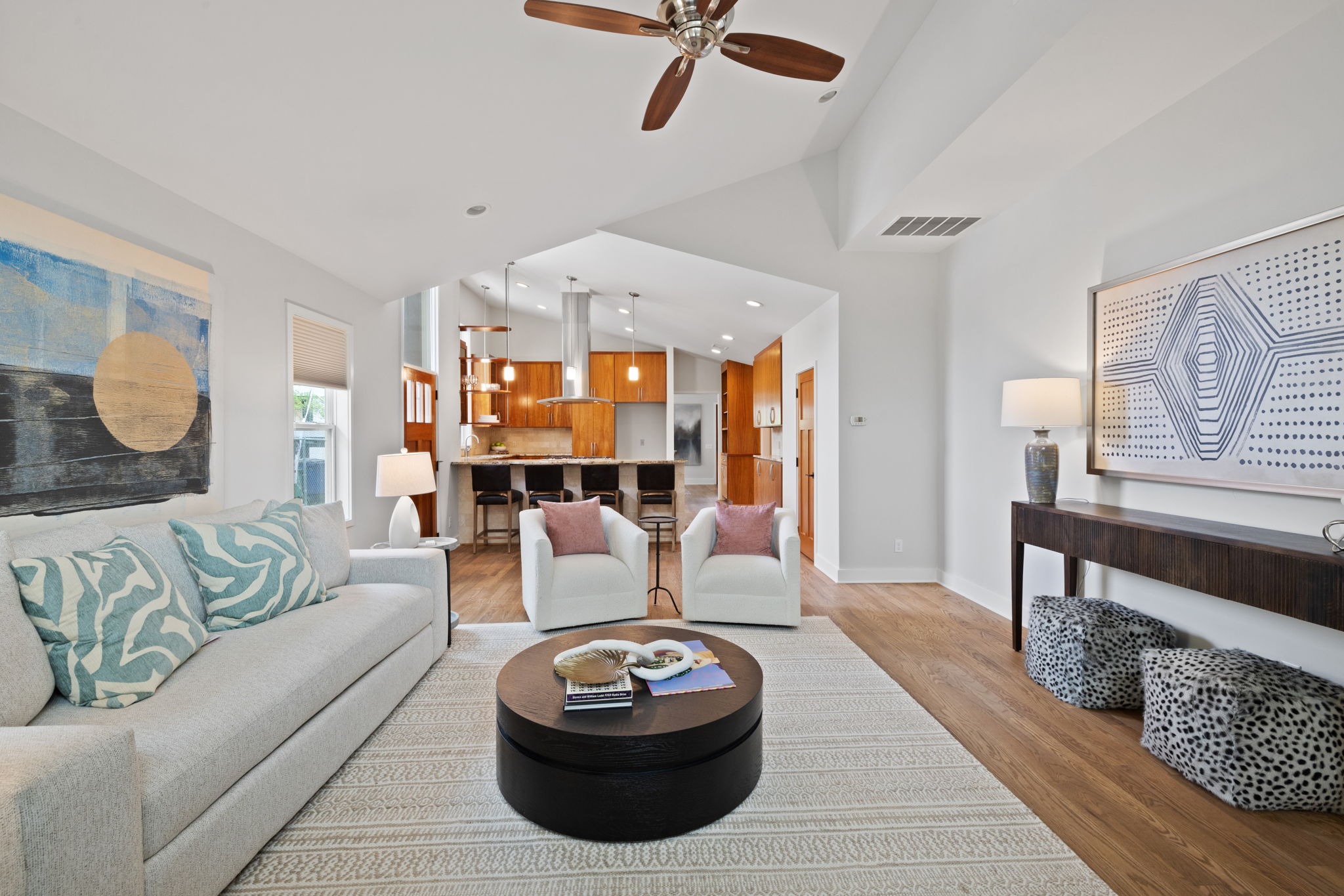 2300 South 3rd Street Austin, TX 78704 - Photo 18 of 39 Living room with light wood-style flooring, vaulted ceiling, baseboards, visible vents, and a ceiling fan