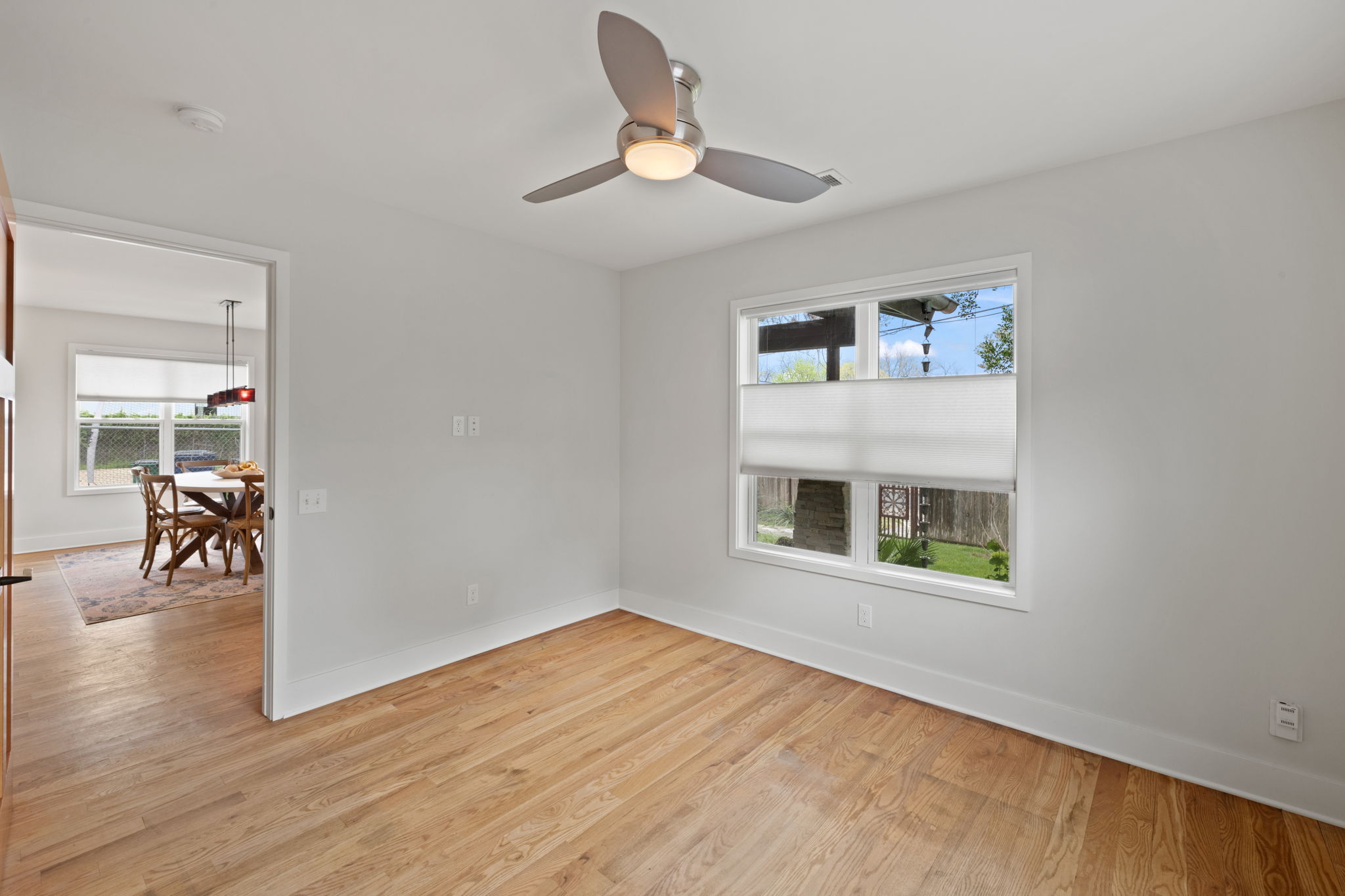 2300 South 3rd Street Austin, TX 78704 - Photo 21 of 39 Empty room with baseboards, light wood-style floors, and a ceiling fan