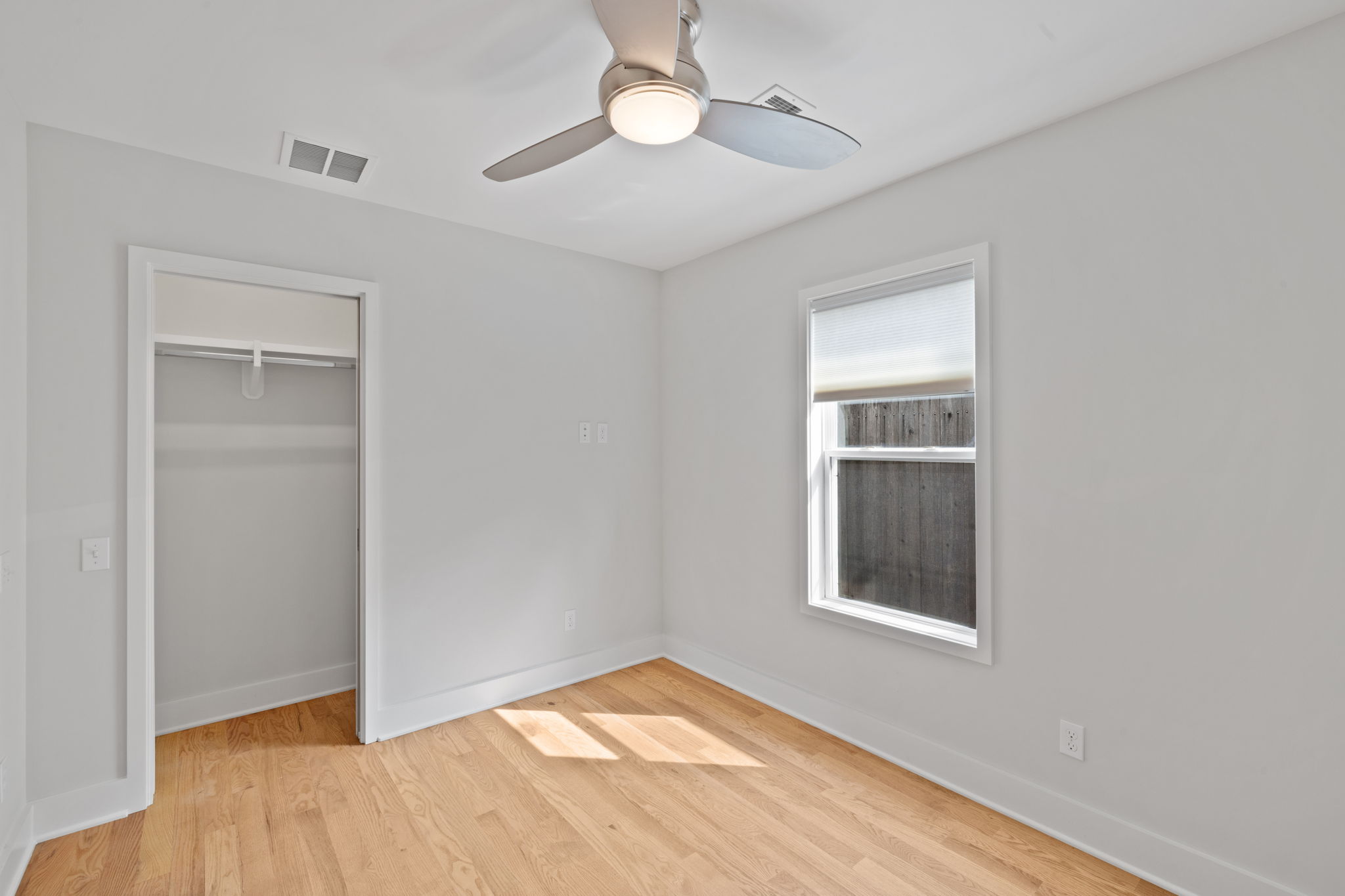 2300 South 3rd Street Austin, TX 78704 - Photo 25 of 39 Unfurnished bedroom with light wood-style flooring, baseboards, a closet, and visible vents
