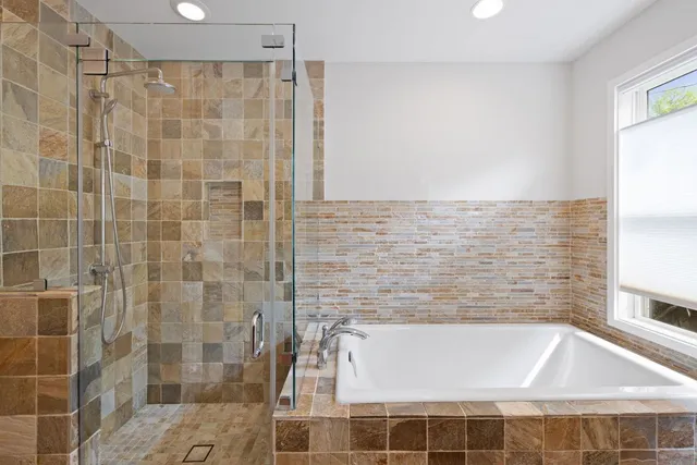 a view of a big room with wooden floor and windows