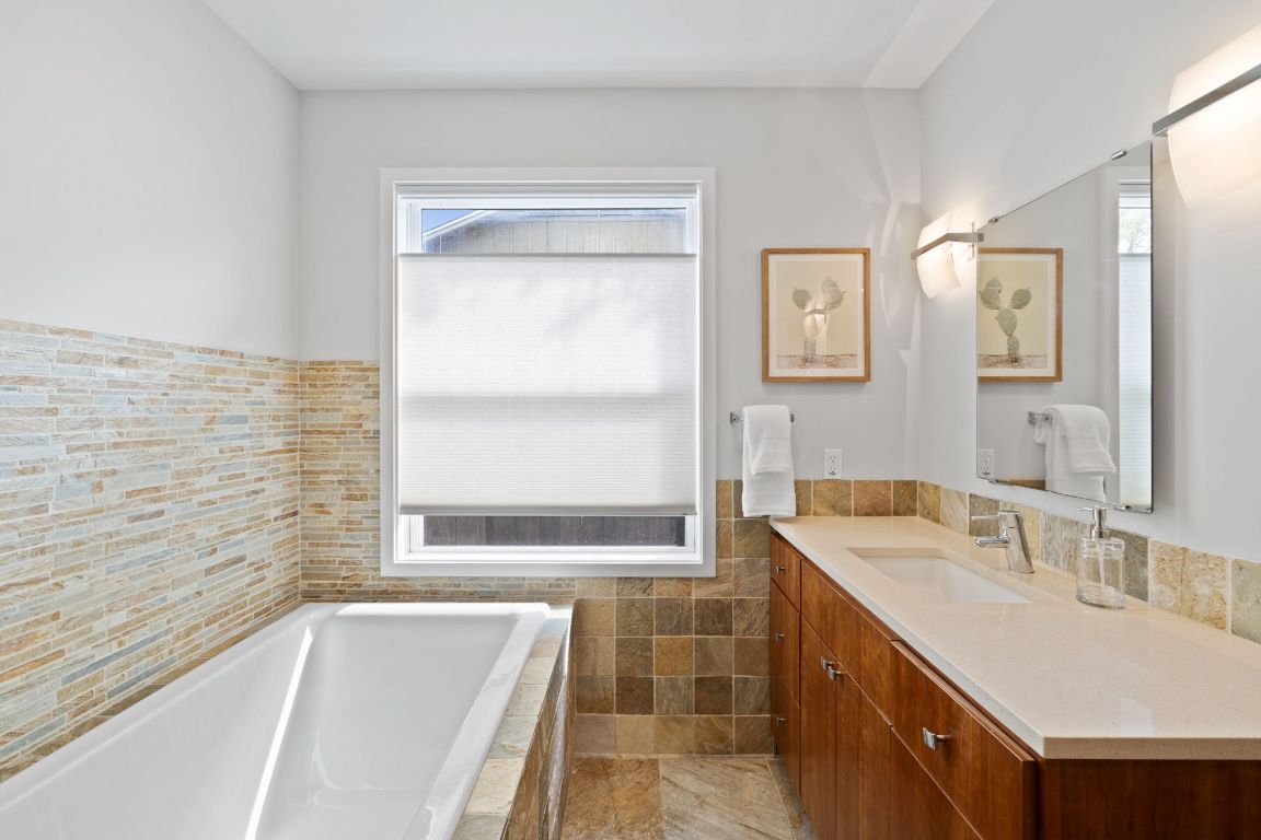 2300 South 3rd Street Austin, TX 78704 - Photo 32 of 39 a bathroom with a tub sink and mirror
