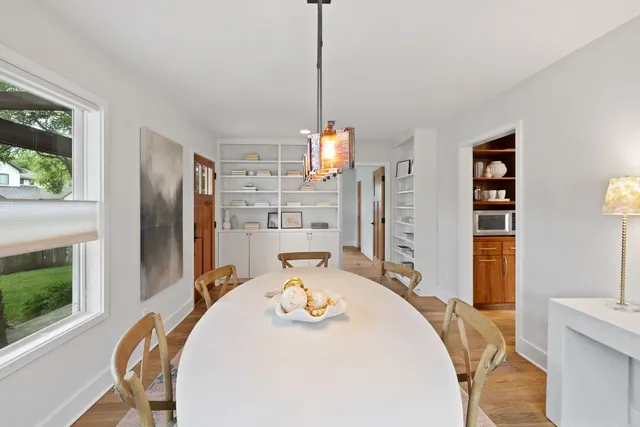 a kitchen with kitchen island granite countertop wooden cabinets and white appliances