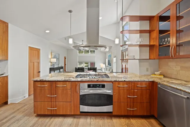a kitchen with stainless steel appliances granite countertop a sink and cabinets