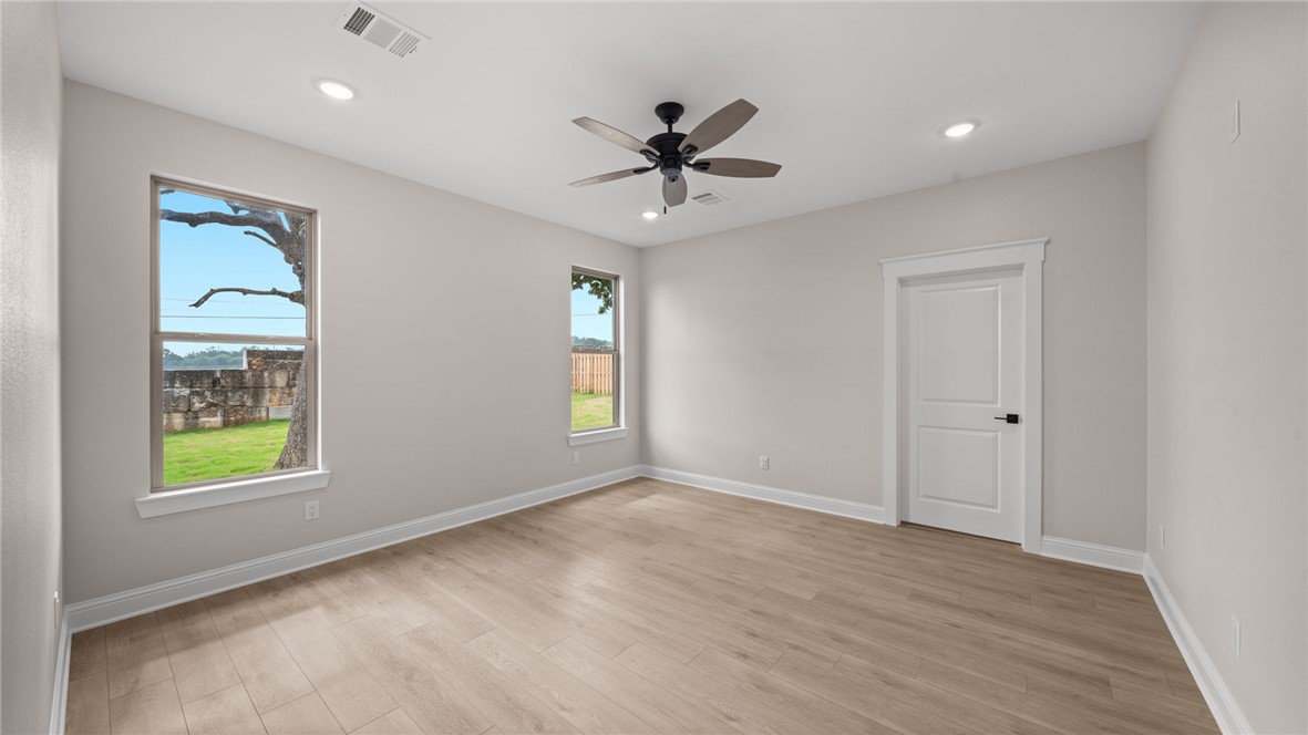 162 Buffalo Rdg Road Giddings, TX 78942 - Photo 12 of 31 wooden floor in an empty room with a window