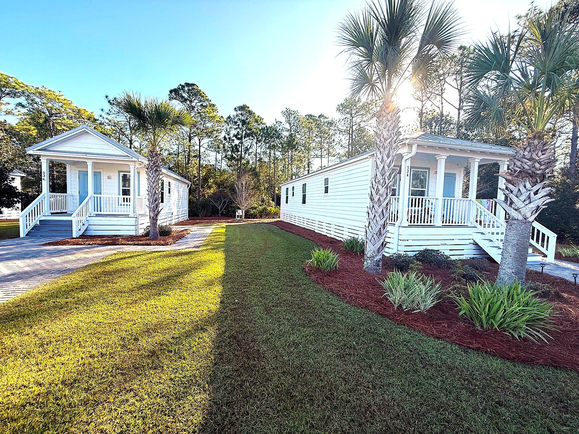 a front view of a house with a garden and plants