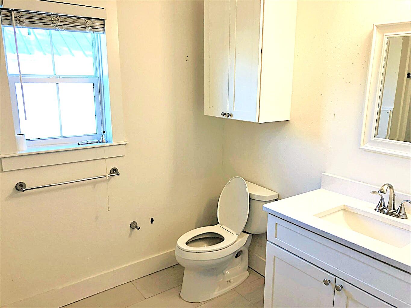 53 Rosin Cup Circle Santa Rosa Beach, FL 32459 - Photo 12 of 22 a bathroom with a toilet a sink and a window