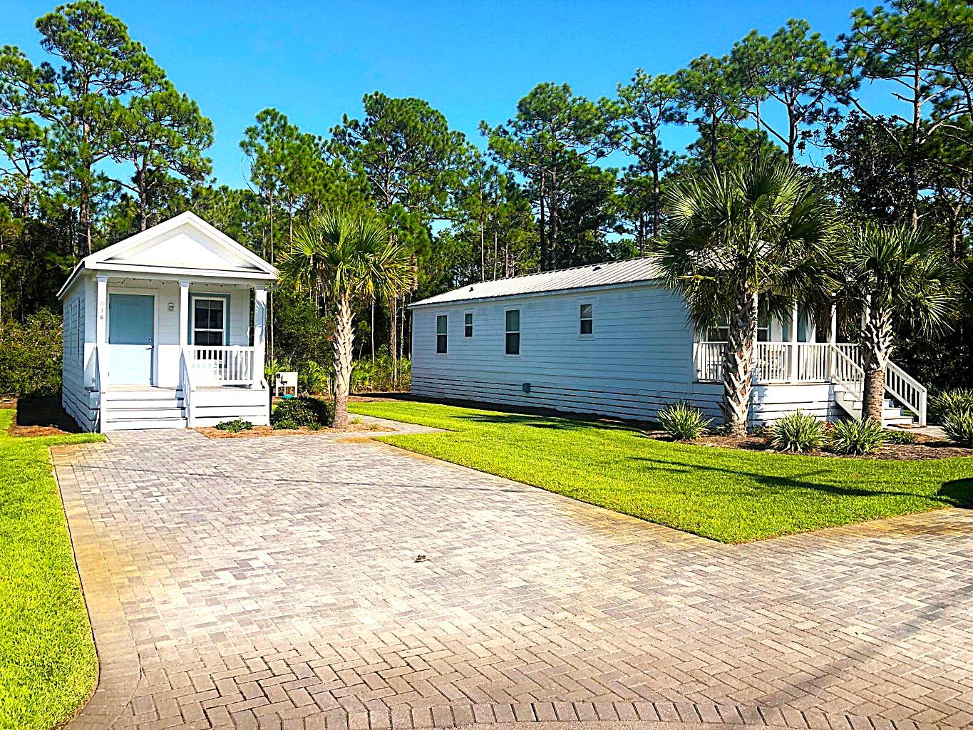 53 Rosin Cup Circle Santa Rosa Beach, FL 32459 - Photo 2 of 22 a front view of a house with a garden and trees